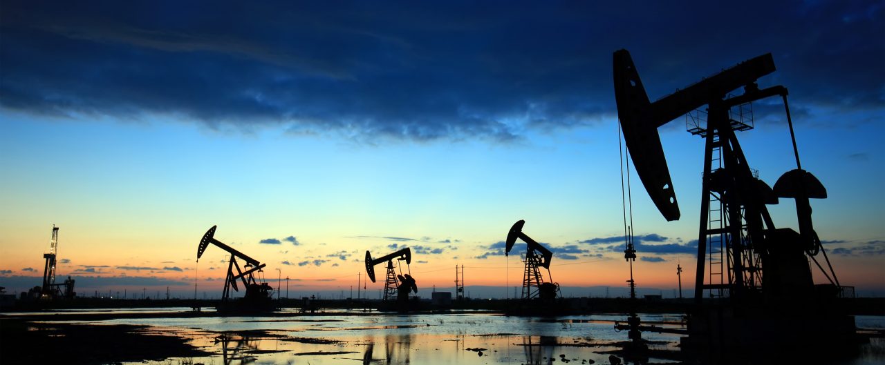 Silhouettes of Oil Pumps in Oil Field at Sunset