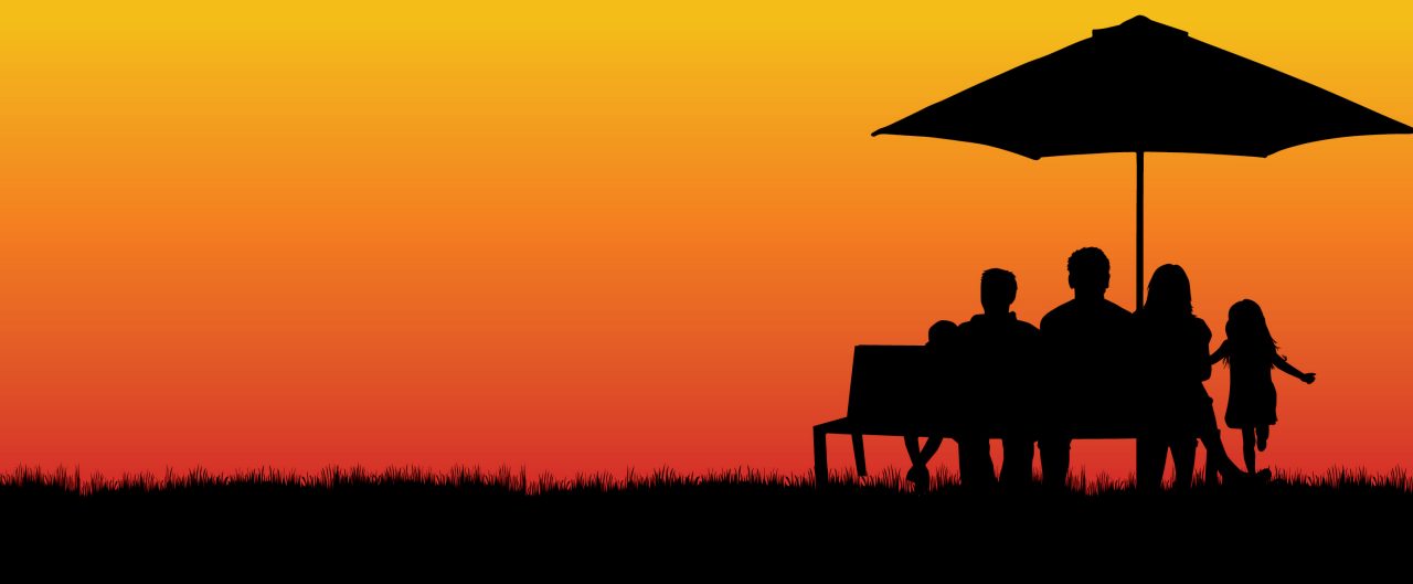 family on bench at sunset
