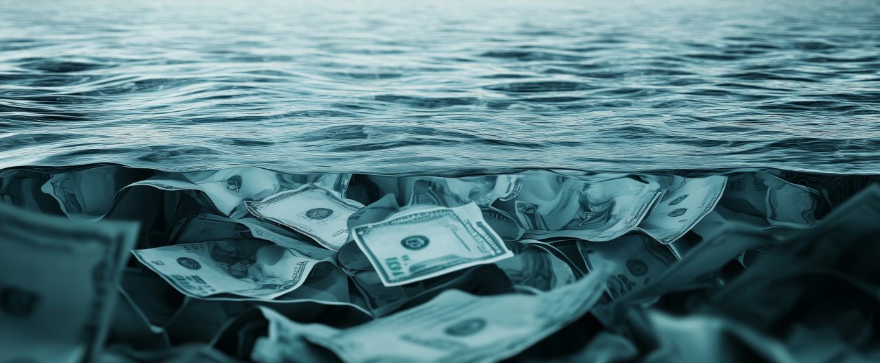 Currency lies submerged beneath turbulent waters, symbolizing the weight of banking defaults and the looming crisis affecting financial institutions globally.