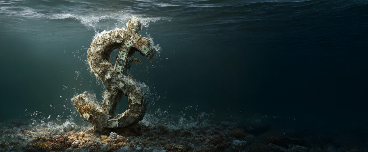 Close up US Dollar sinking in water as symbol of global economic and financial crisis and recession. 