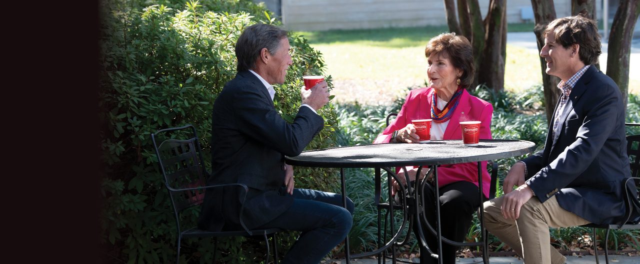 Donna Saurage conversing with Matt and Hank Saurage 