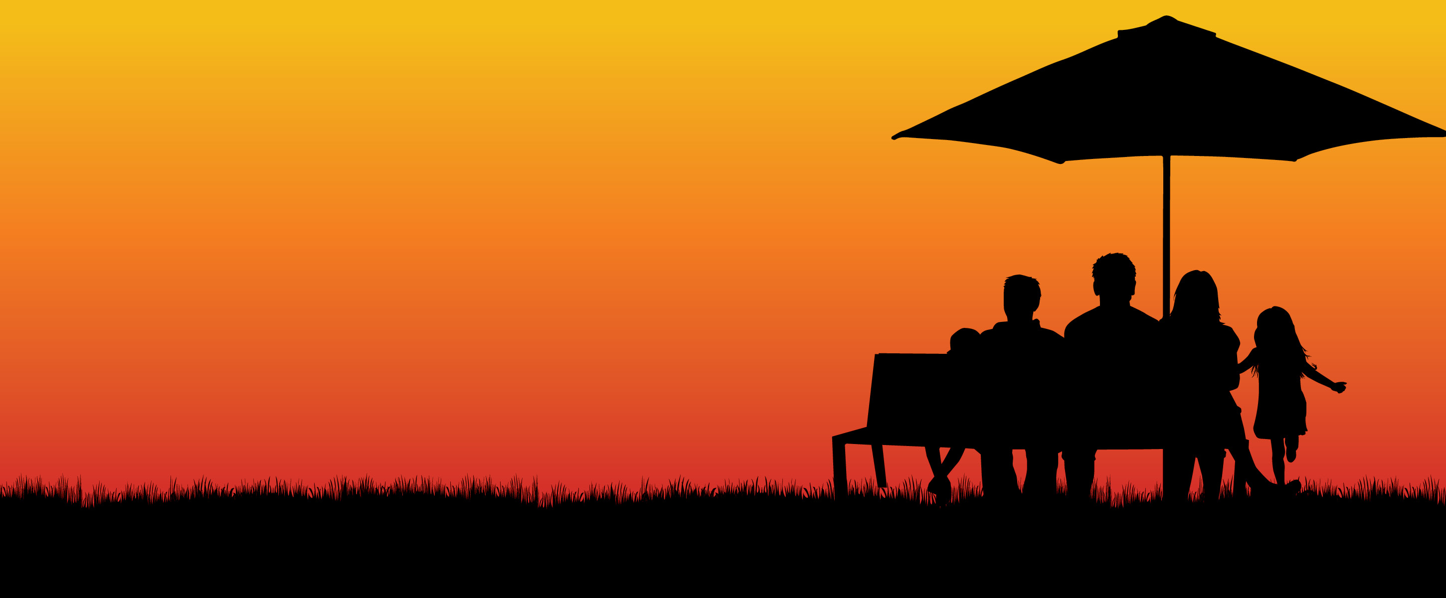 family on bench at sunset