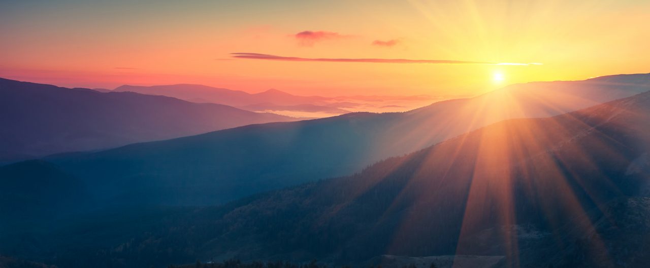 Panoramic view of  colorful sunrise in mountains. 