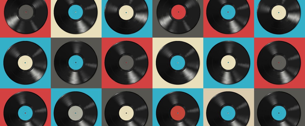Vinyl records with colorful labels on colorful background.