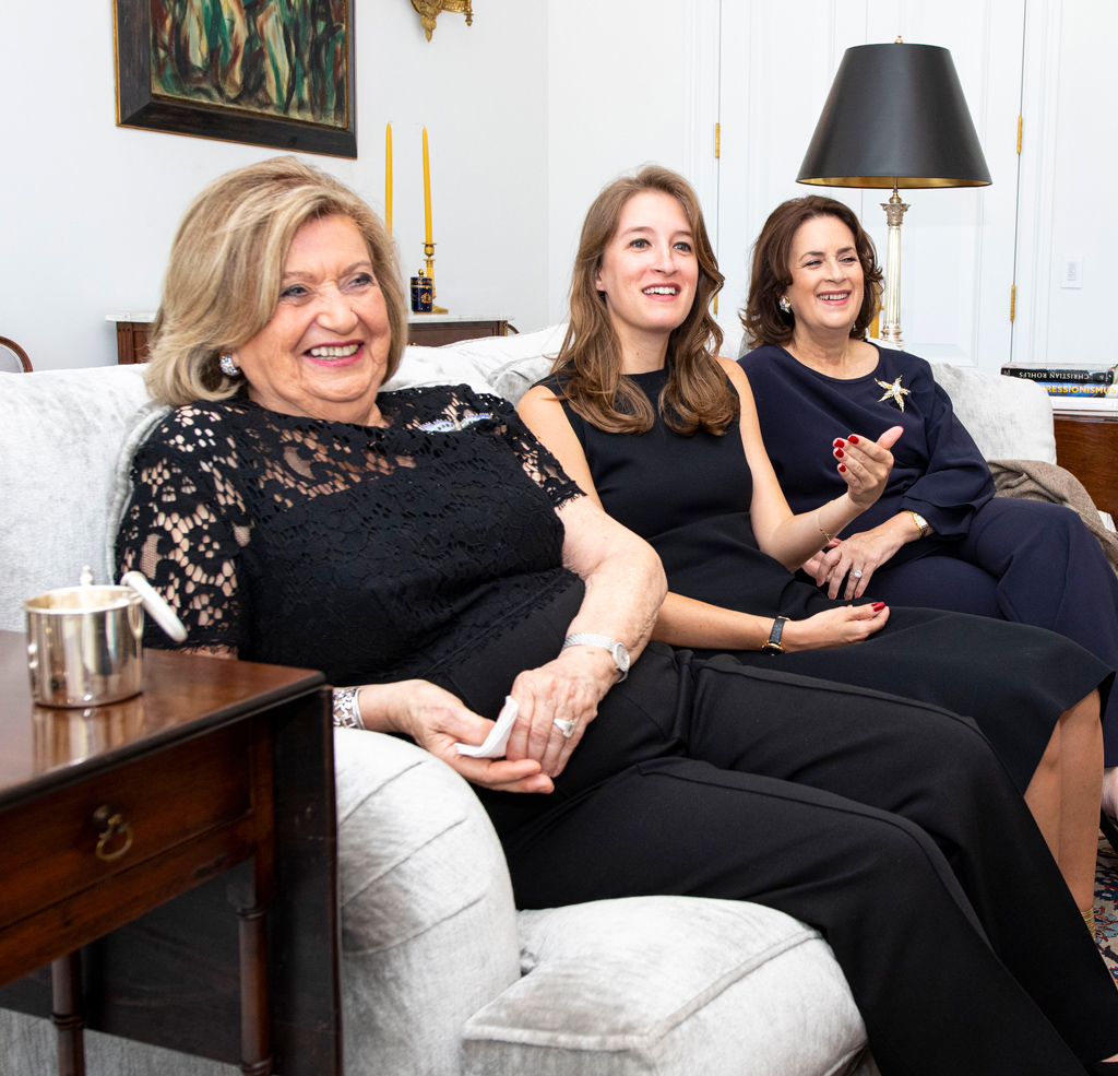 Three women sitting together on couch