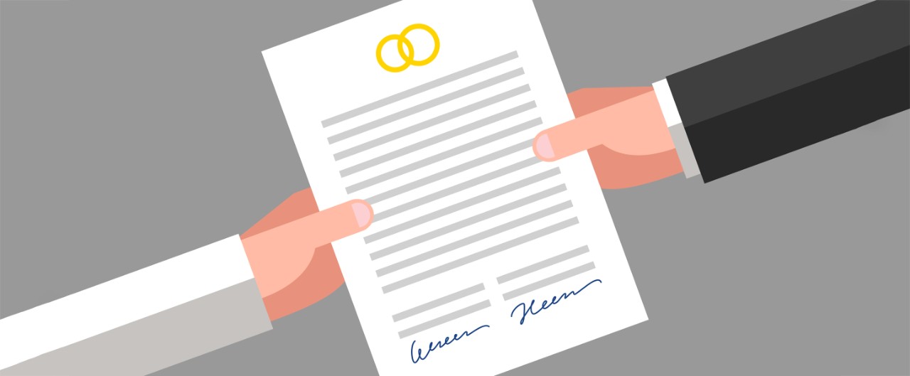 Prenuptial agreement in man and woman hands. Family and law concept
