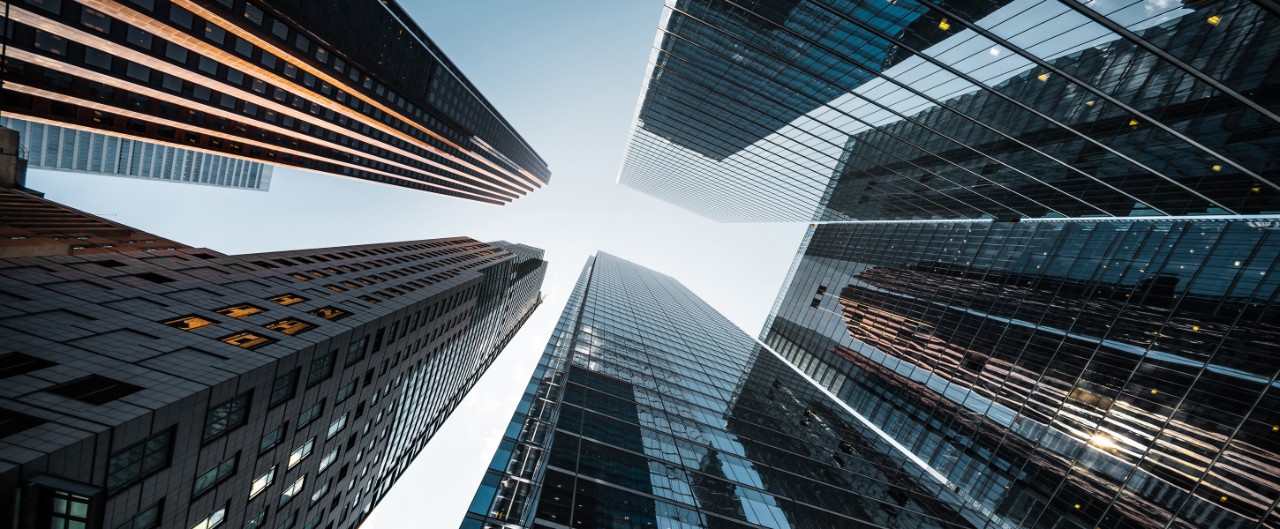 Business and finance concept, looking up at futuristic skyscrapers in the financial district of a modern metropolis.