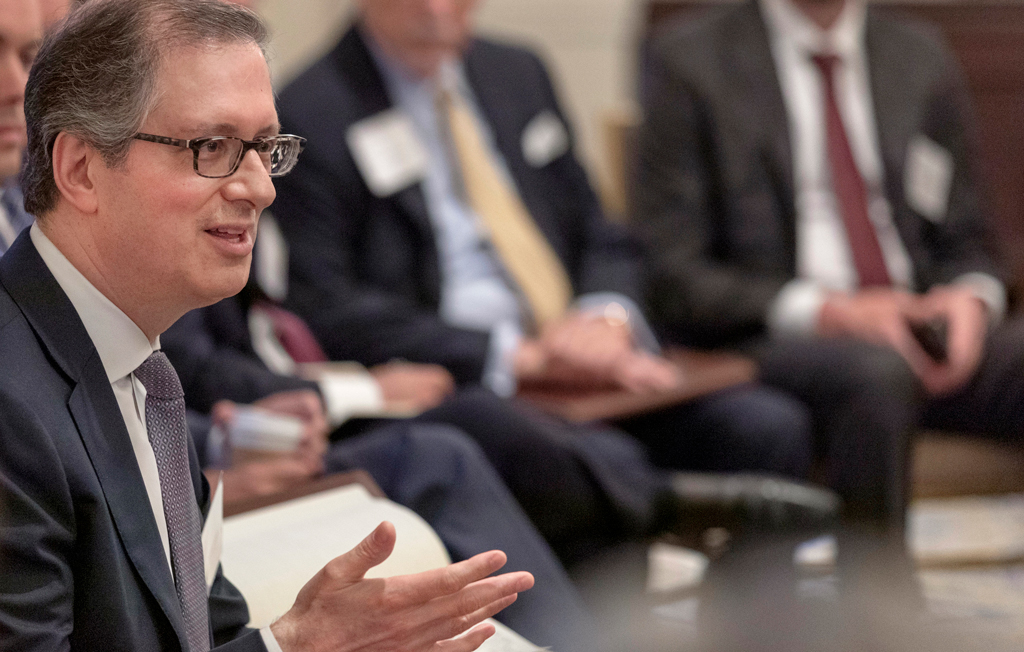 A businessman speaking at a conference