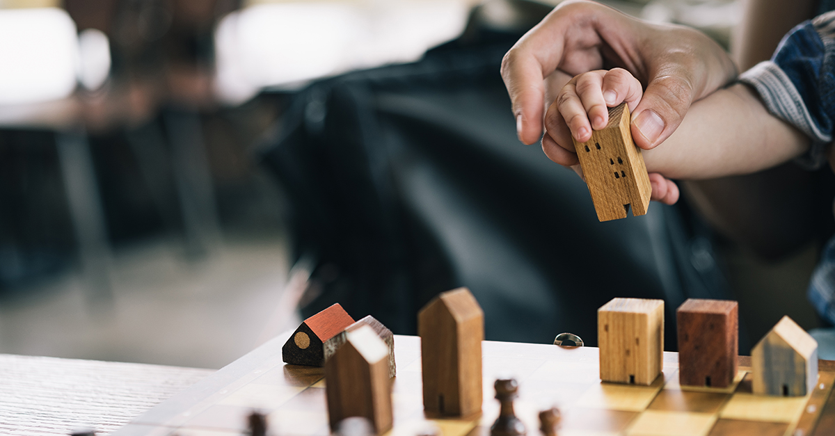 Baby Hands holding a house model with mother hand. The concept of relocation, mortgage, inheritance, family assurance protection and legacy planning.