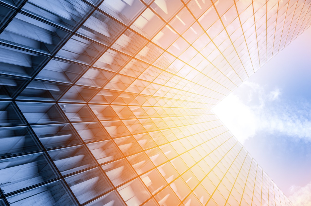 Upward view of a skyscraper with sunlight