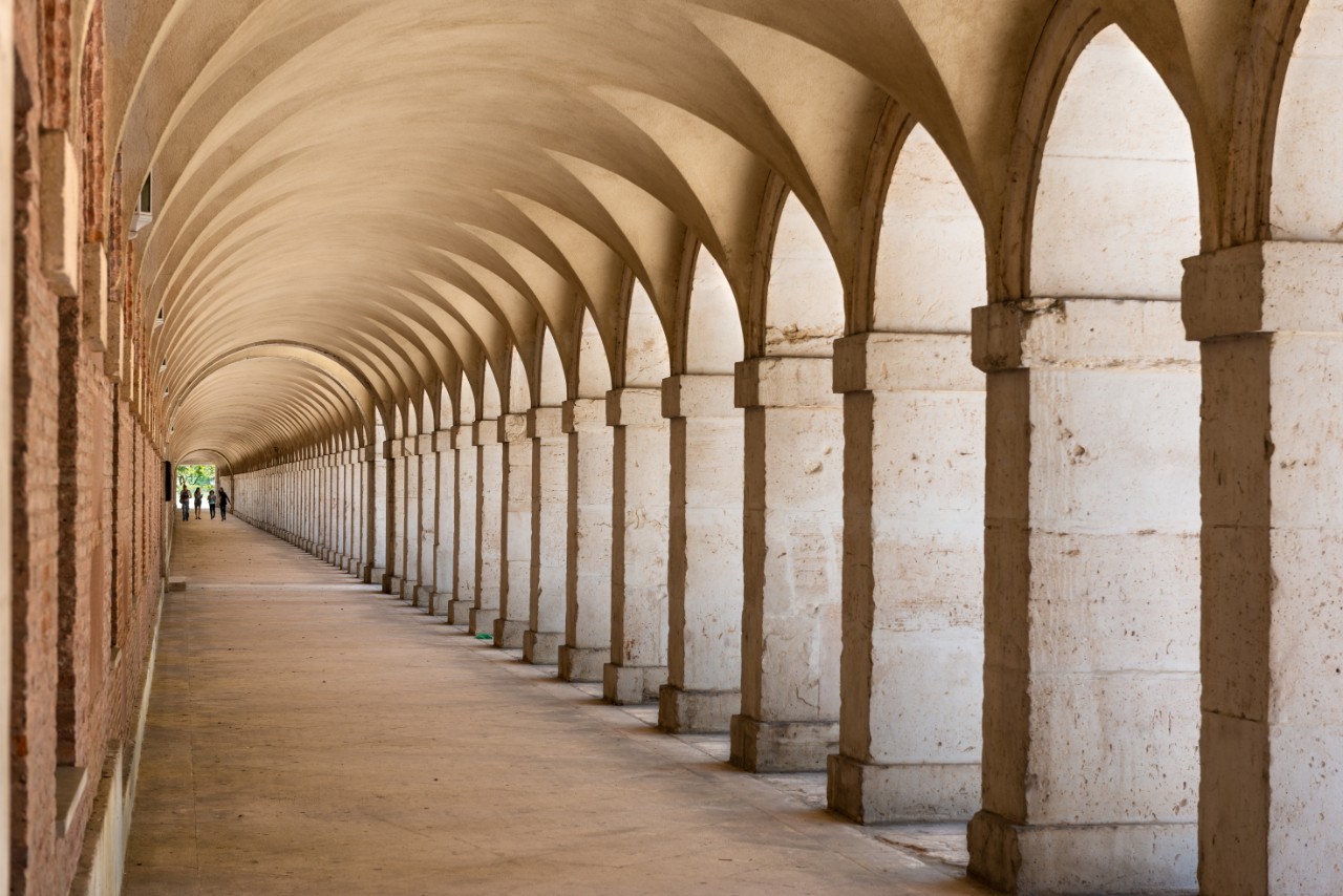 Details of an old stone arched walkway with stone columns