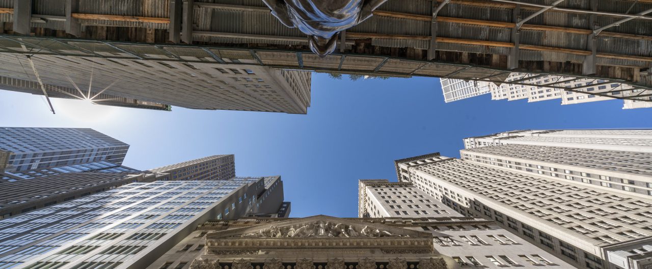 New York Stock Exchange and statue taken from down below with a clear blue sky_banner
