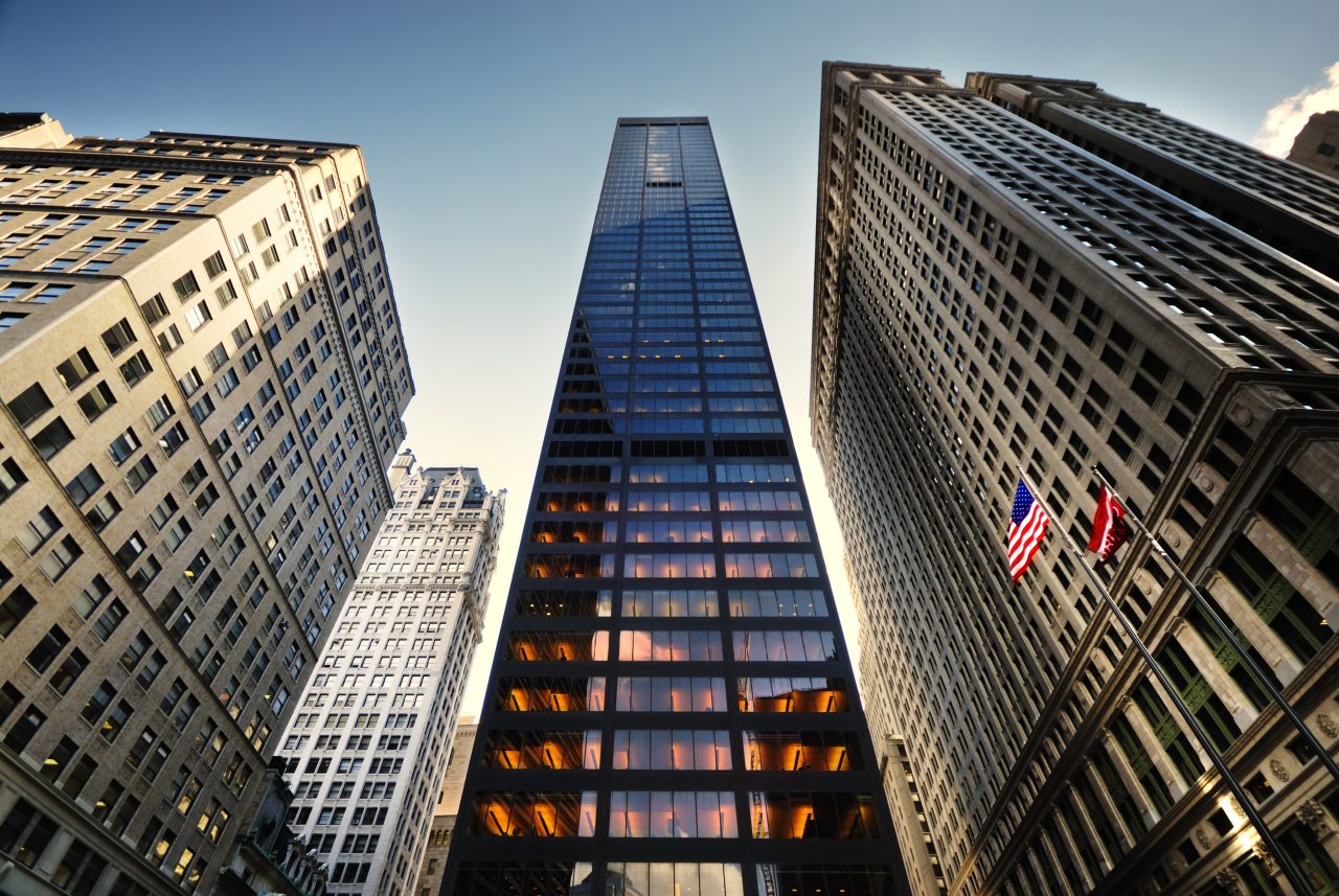 Upward View of Skyscrapers w/ two Flags to the Right