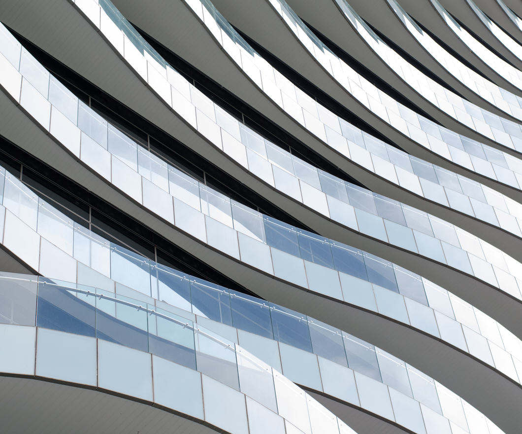 Glass wave-like balconies lining a building